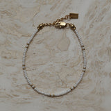 Armbandje goud en wit design, Witte kralen armband met gouden accenten